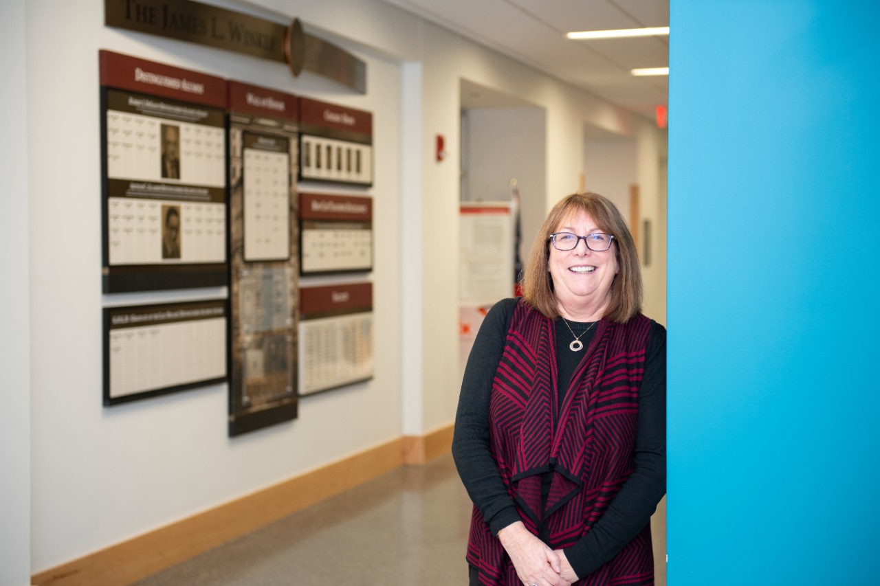 Andrea Wall leaning on a wall at the pharmacy college