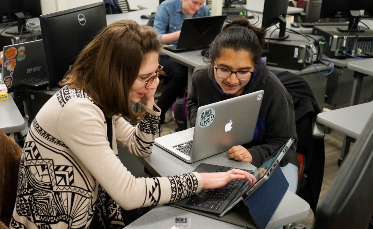 two students work on computer together