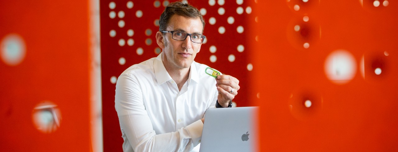 UC professor Jason Heikenfeld holds up a sweat sensor at the 1819 Innovation Hub.