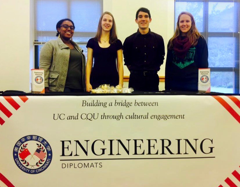 Laura Stegner and engineering classmates stand behind their Engineering diplomats banner.