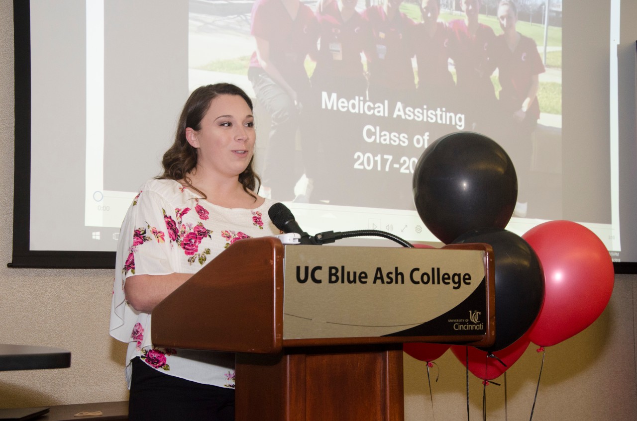 Medical Assisting Student at pinning ceremony lectern