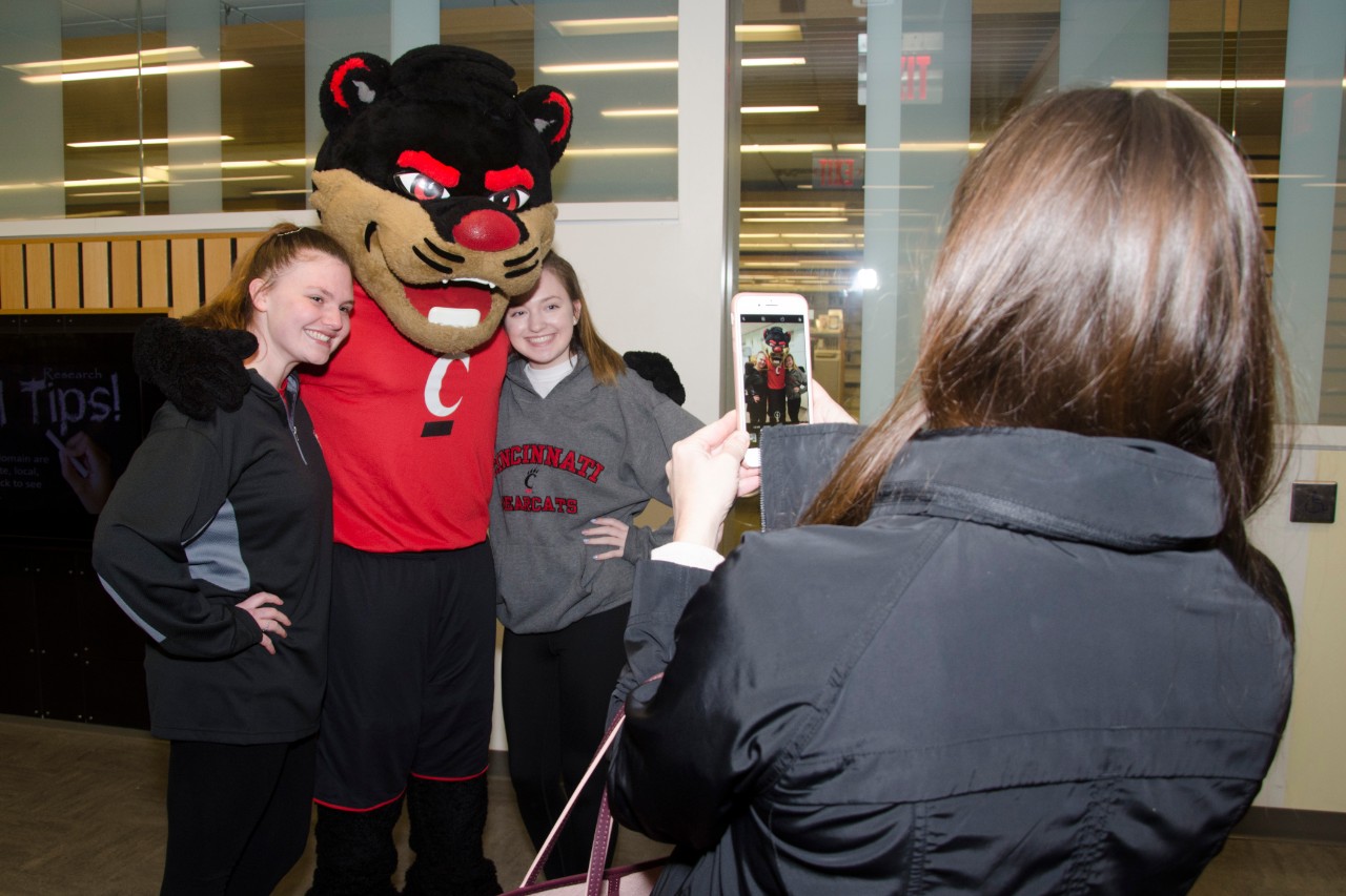 Students posing with the Bearcat mascot