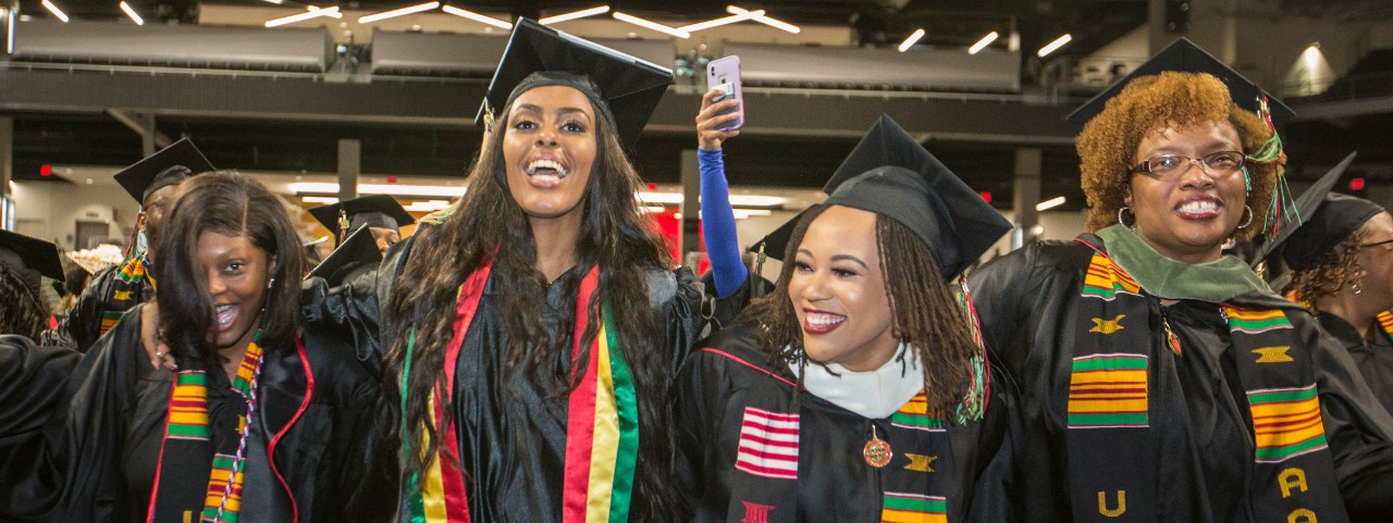 Four UC graduates laugh during Tyehimba.