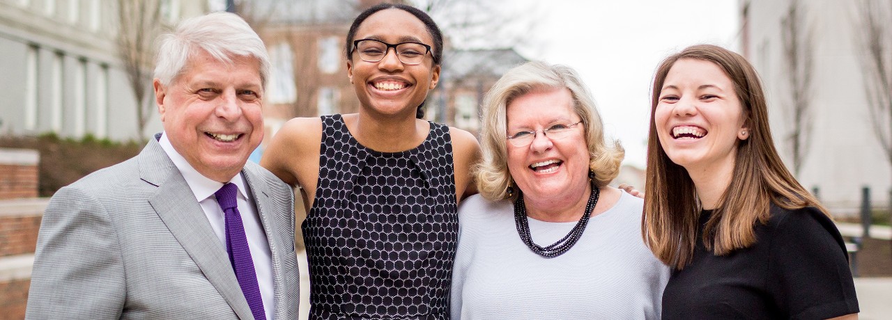 Four people, smiling