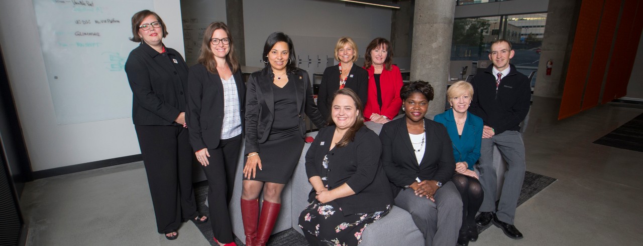 UC 2019 Staff Senate sit together on a couch in UC's 1819 iHub.