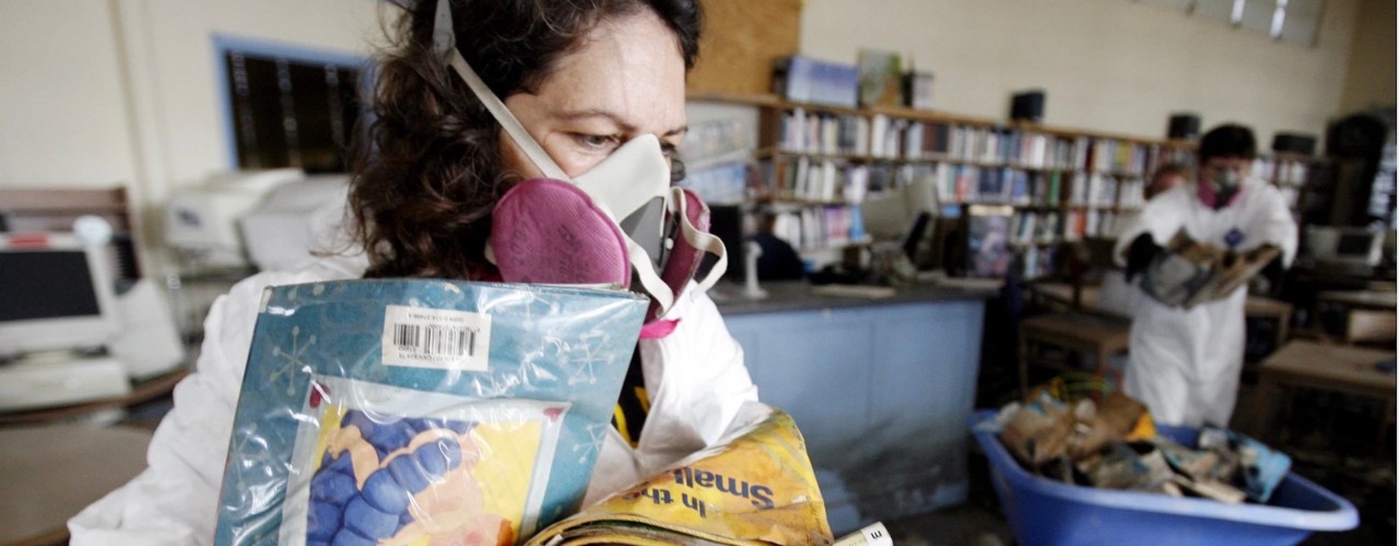 Woman with face mask carried plastic-wrapped archives