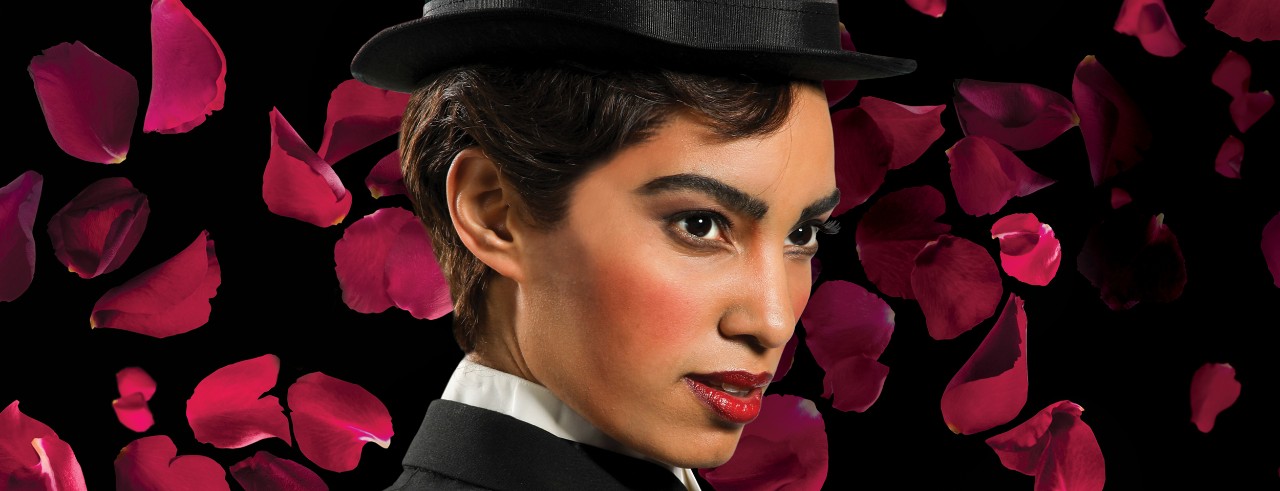 Woman disguised as a man poses for the camera. 