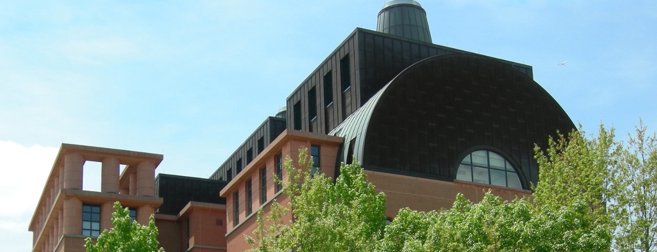 photo of engineering research center during the day with trees in foreground