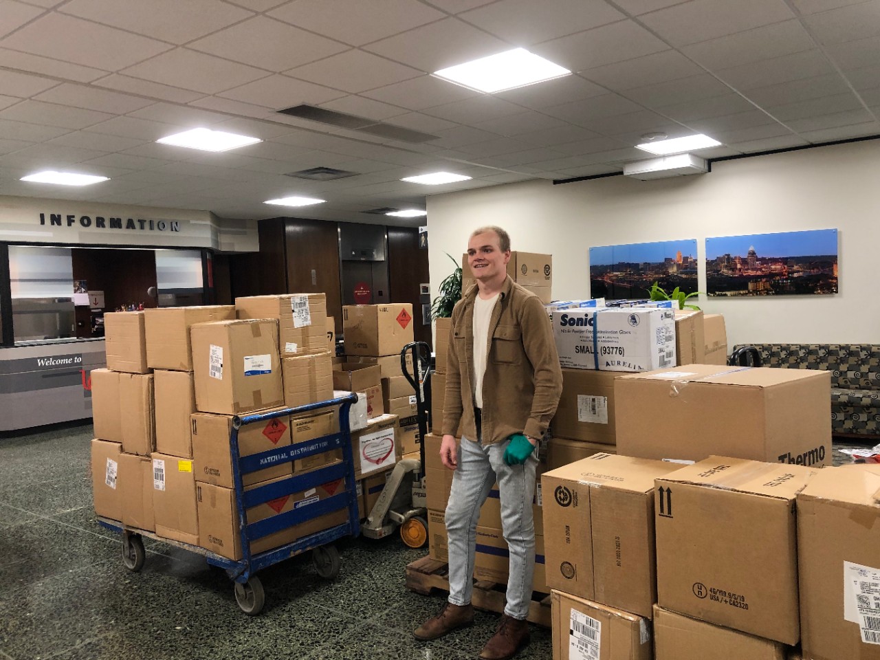 Jack Hinders stands among boxes