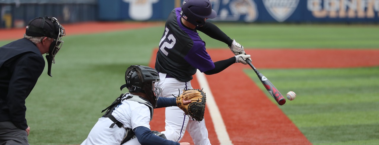 Baseball batter hitting the ball with catcher and umpire behind him.