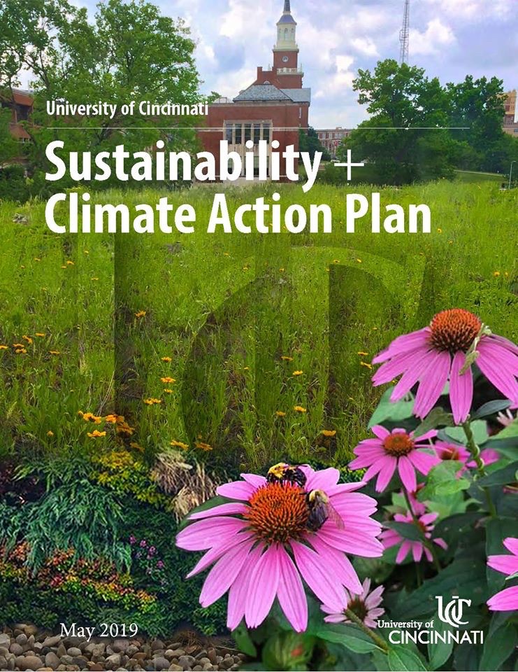 Front cover of UC's Sustainability and Climate Action Plan showing pink daisies in foreground with McMicken Hall in background.