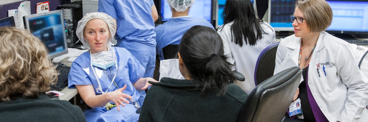 Dr Amy Thompson speaking with doctors