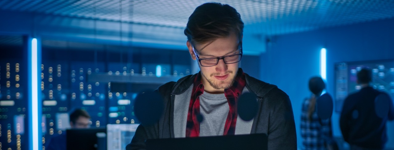Young man working at desk in cybersecurity department