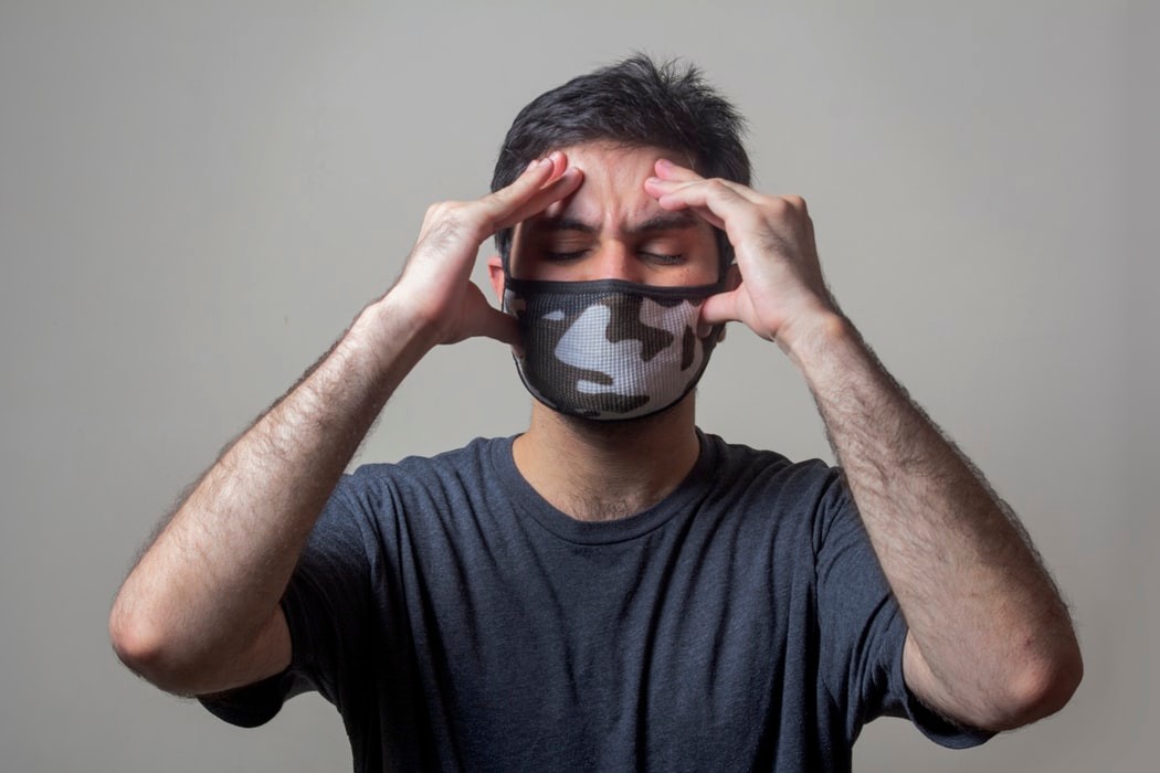 man with mask has headache