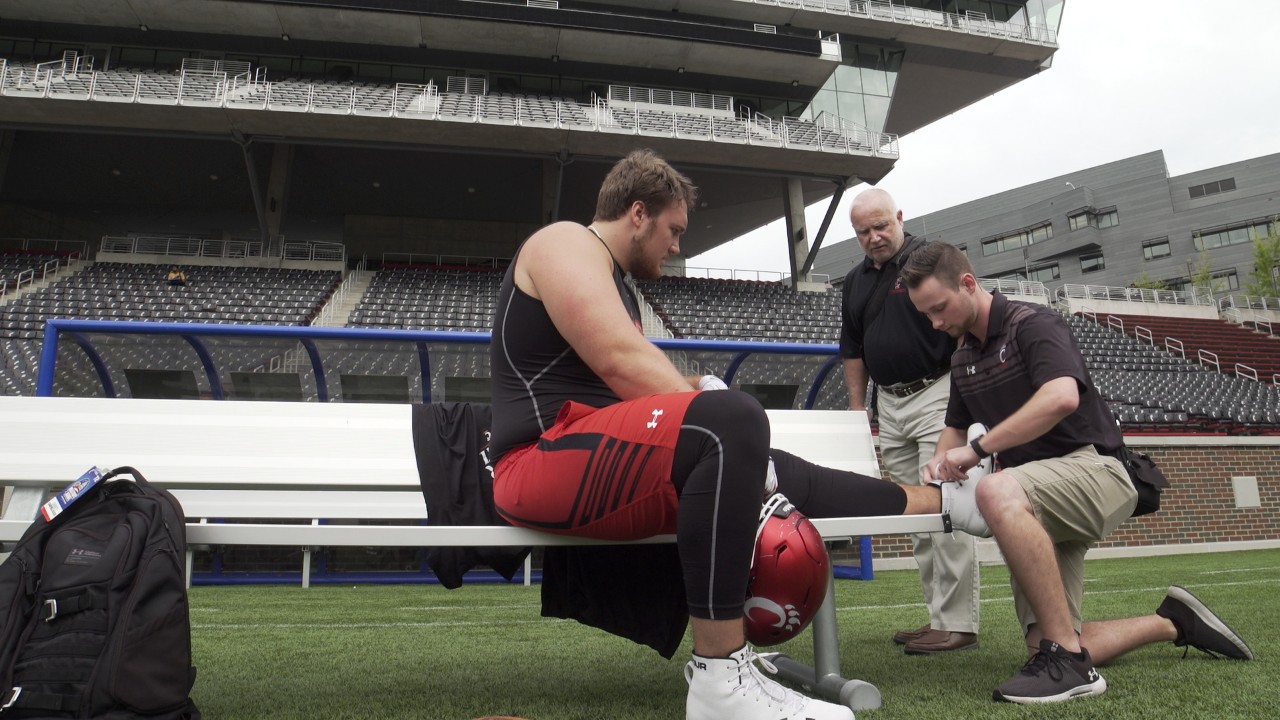 Athletic Training Professor and Student wrapping Athlete's foot
