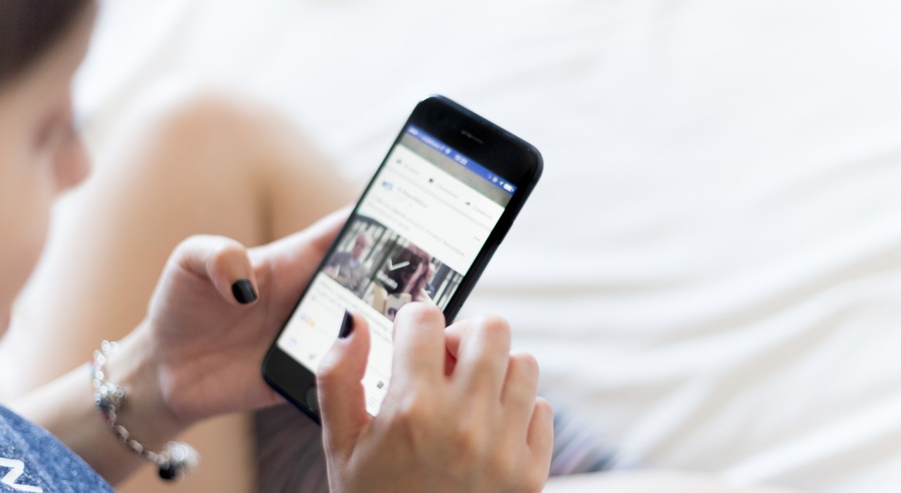 Person scrolling through their cell phone