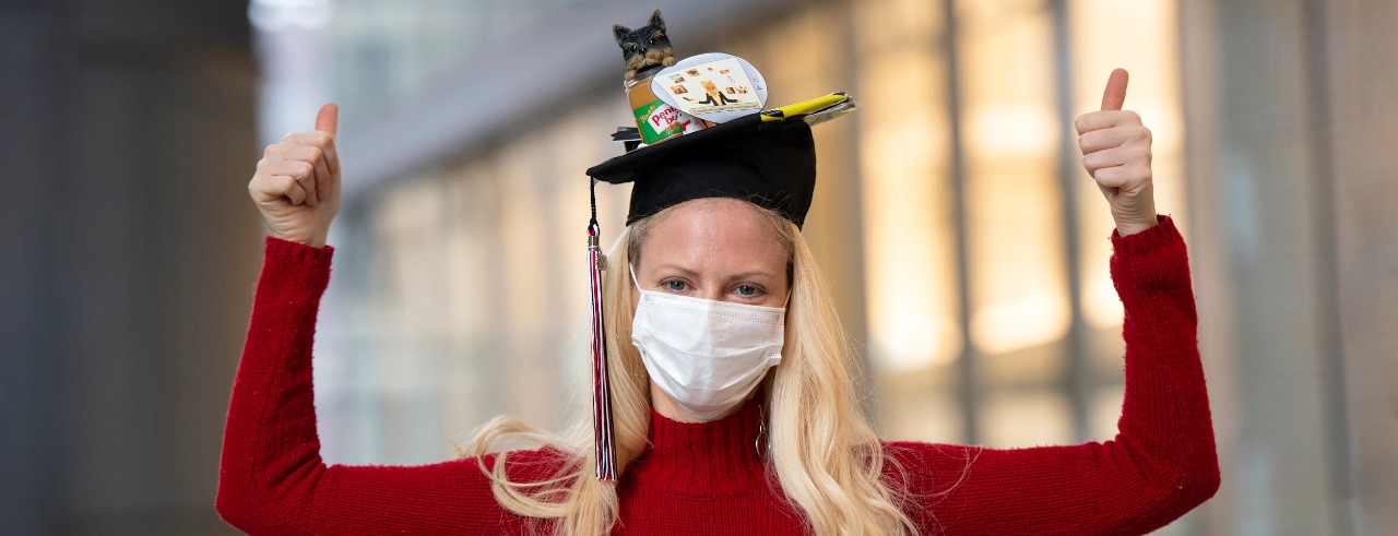 Angela White wearing a mask and cool graduation hat.