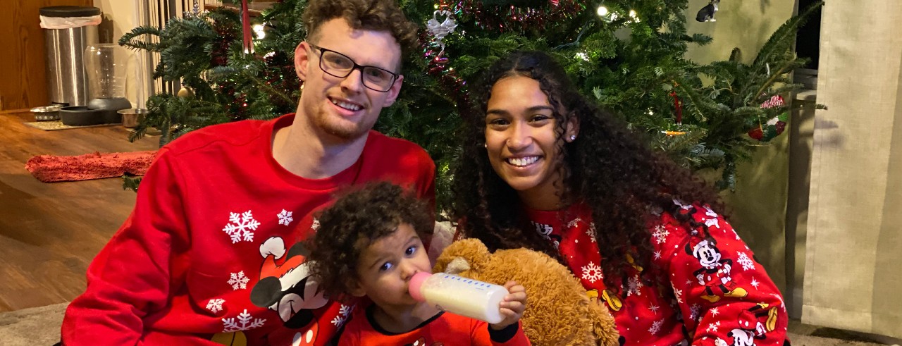 young couple and daughter with bottle