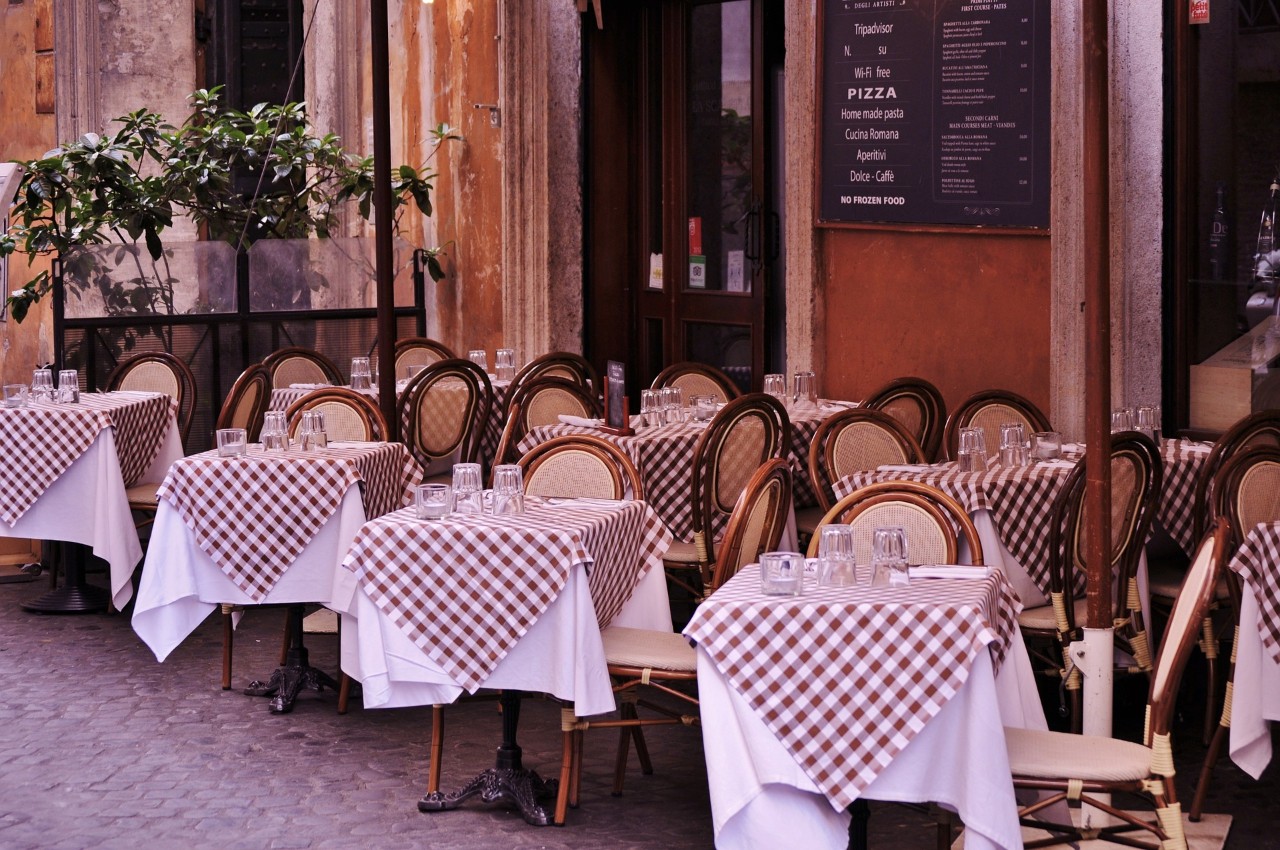 Empty tables and chairs at an outdoor cafe