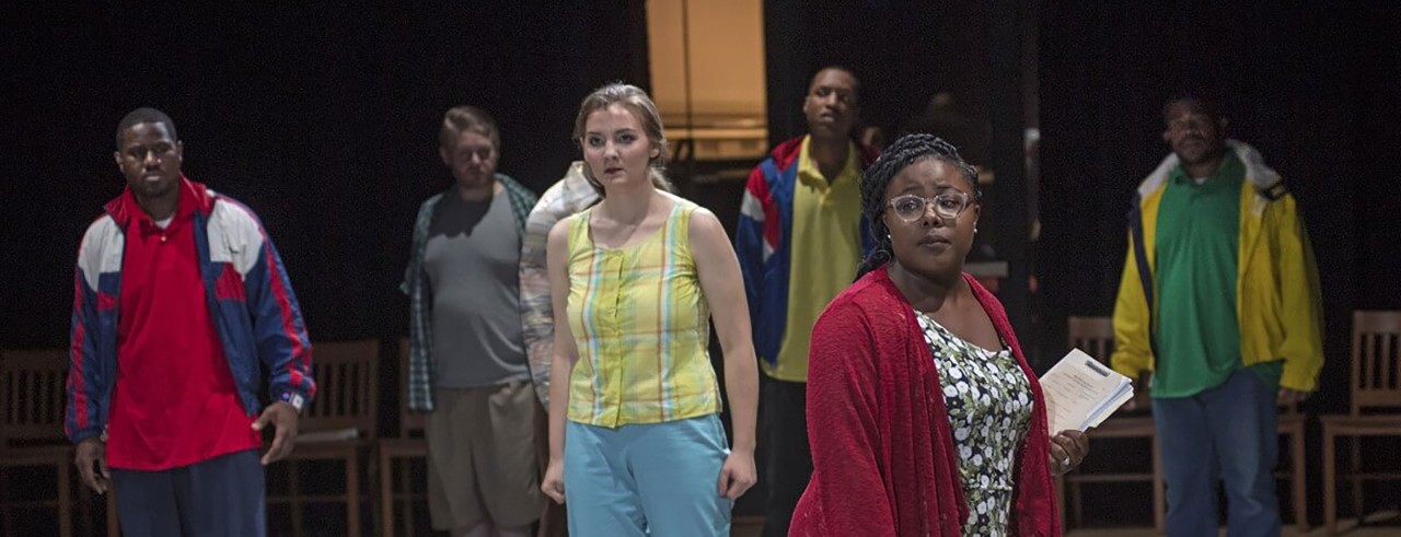 Performers singing on stage during the Blind Injustice workshop