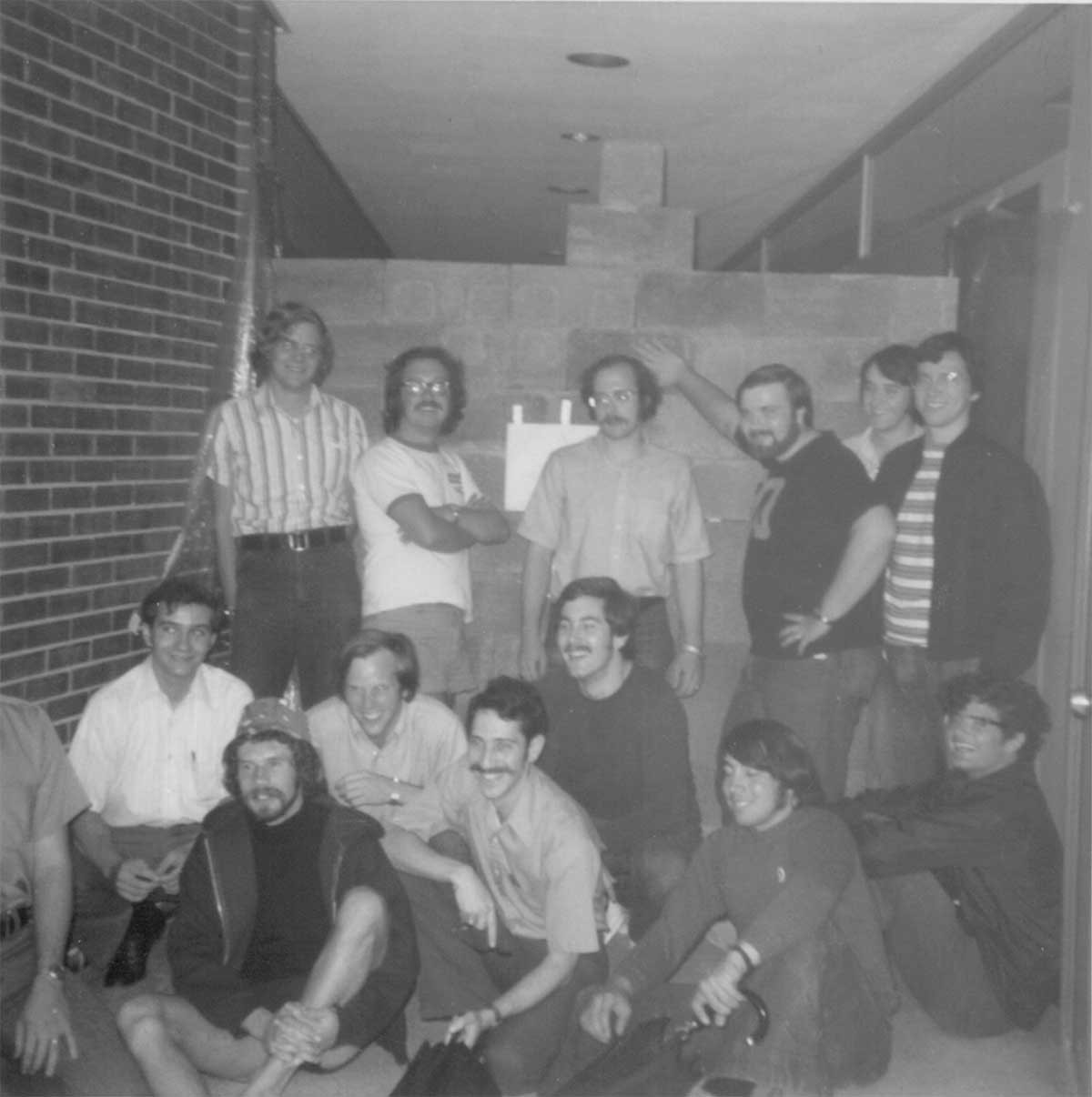 Ralph Spitzen and his classmates posing with their senior prank, a concrete wall in Rhodes Hall.