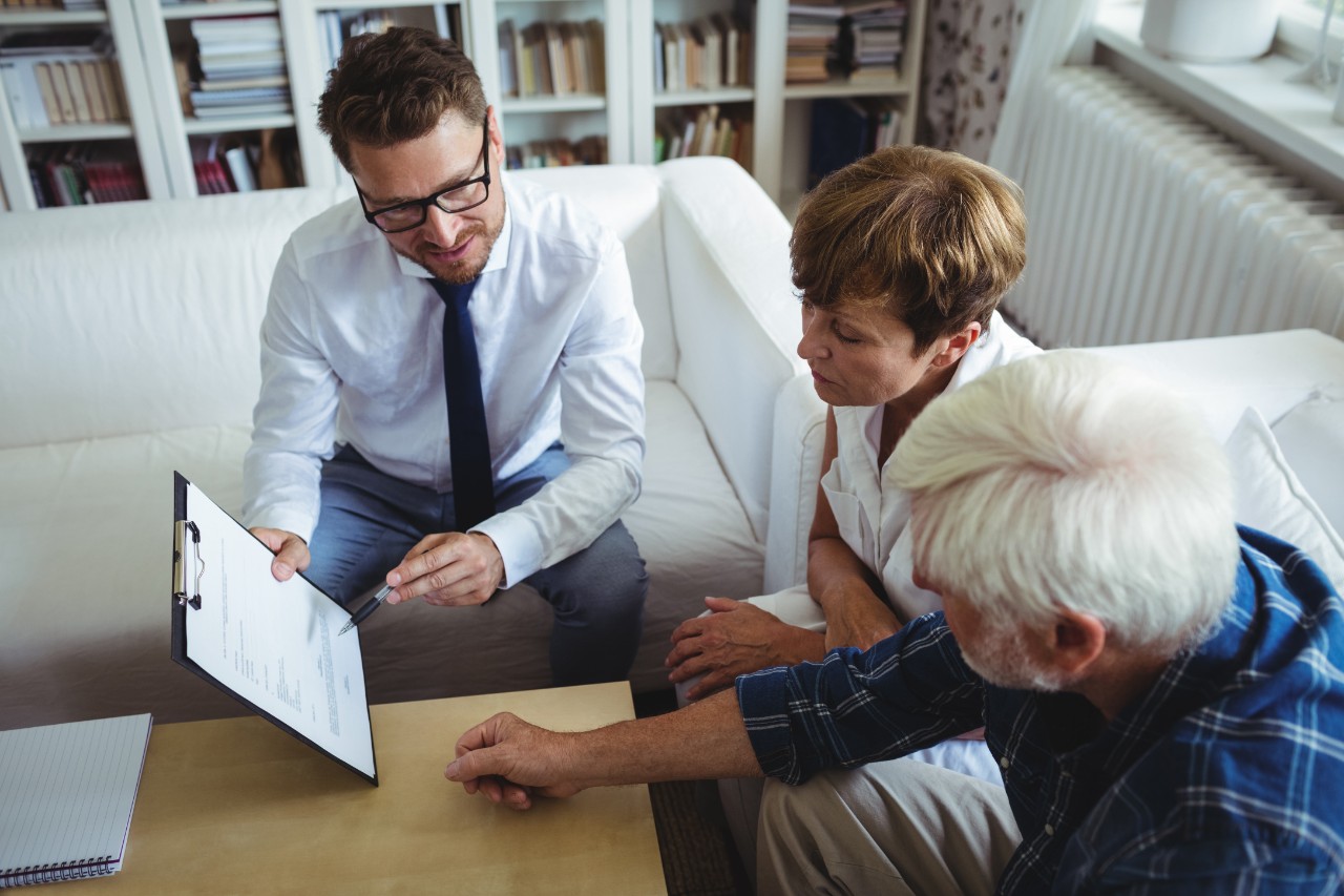 Financial advisor talks with clients