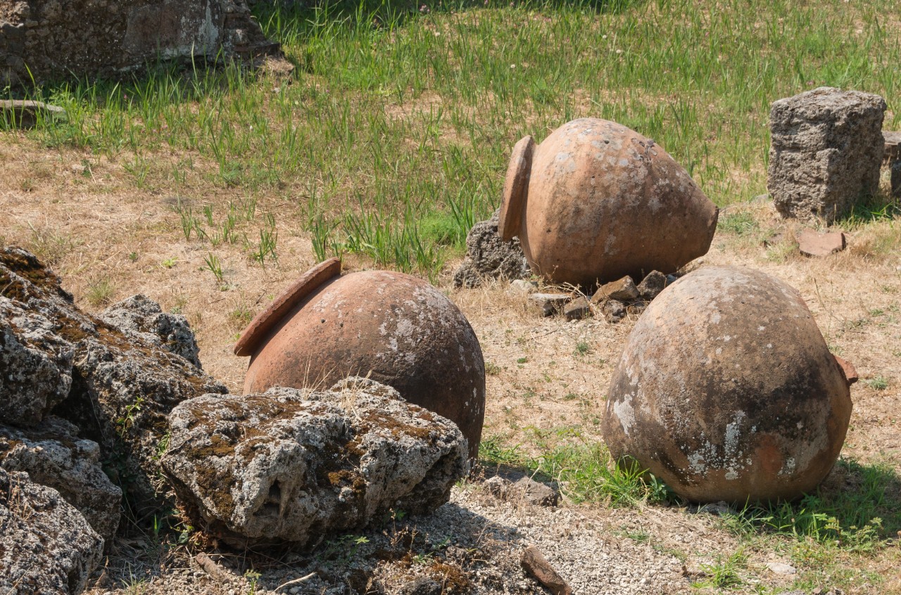 Abandoned vases sit on the ground.