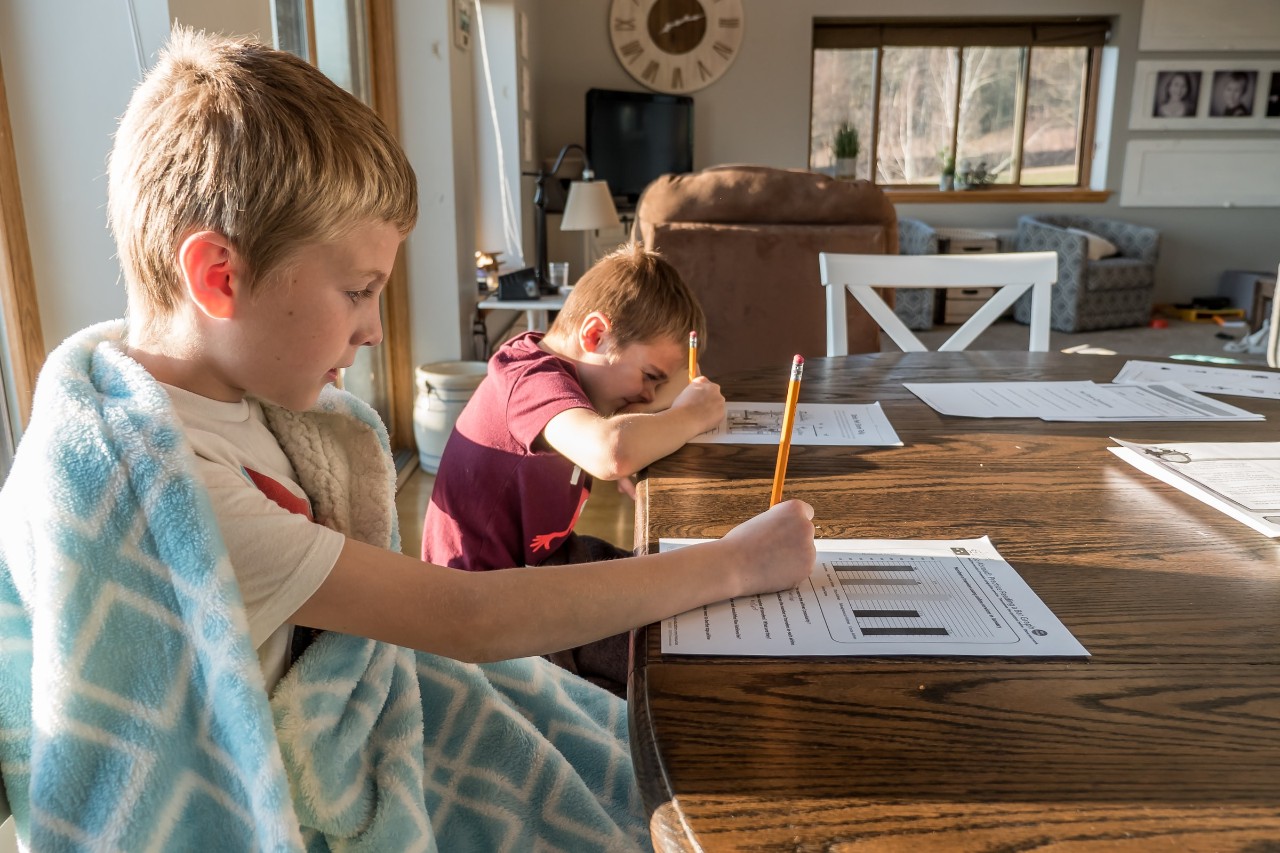 kids at kitchen table studying at home