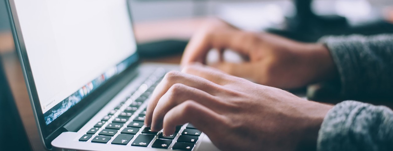 Person typing on a laptop.