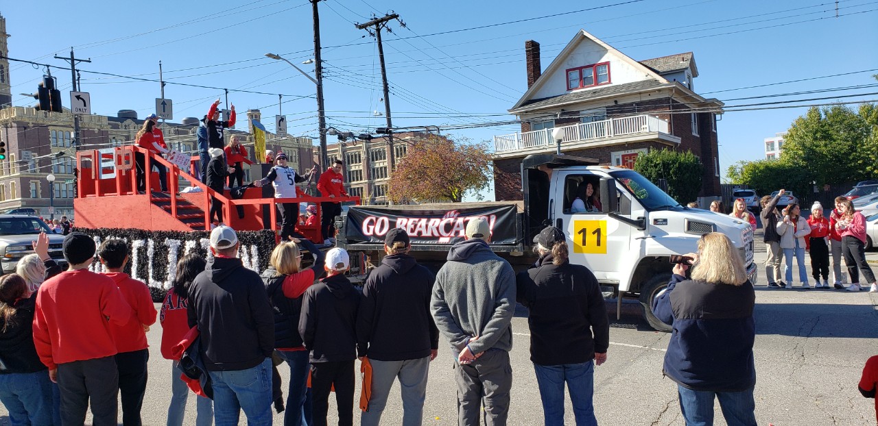 Homecoming parade float with parade attendees