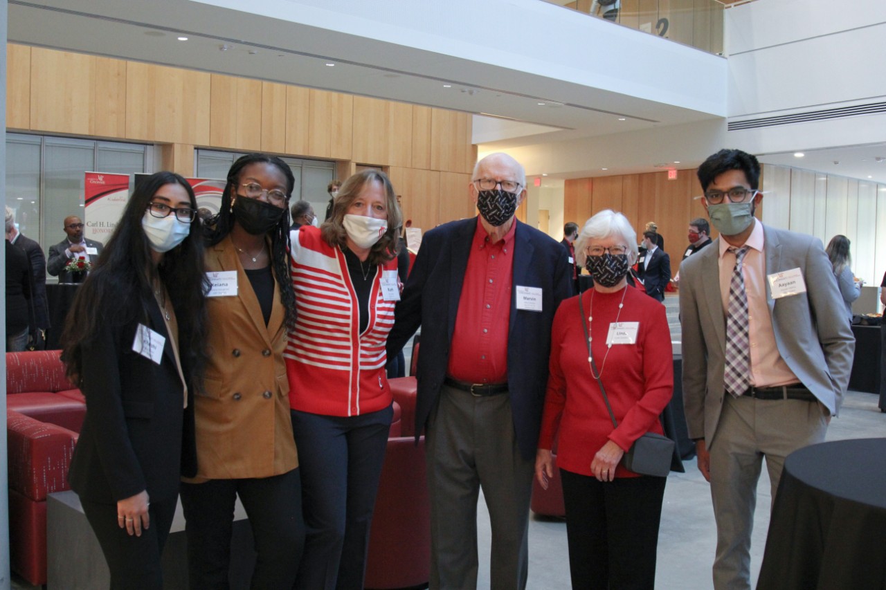 Six people pose for a photograph at an event.