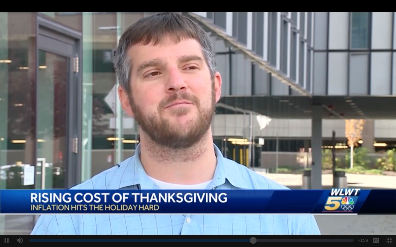 Man stands outside during a television interview.