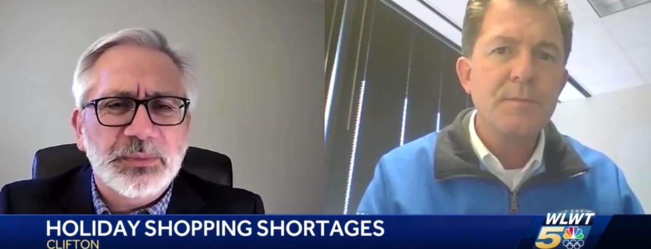 Two men as part of a television news story.