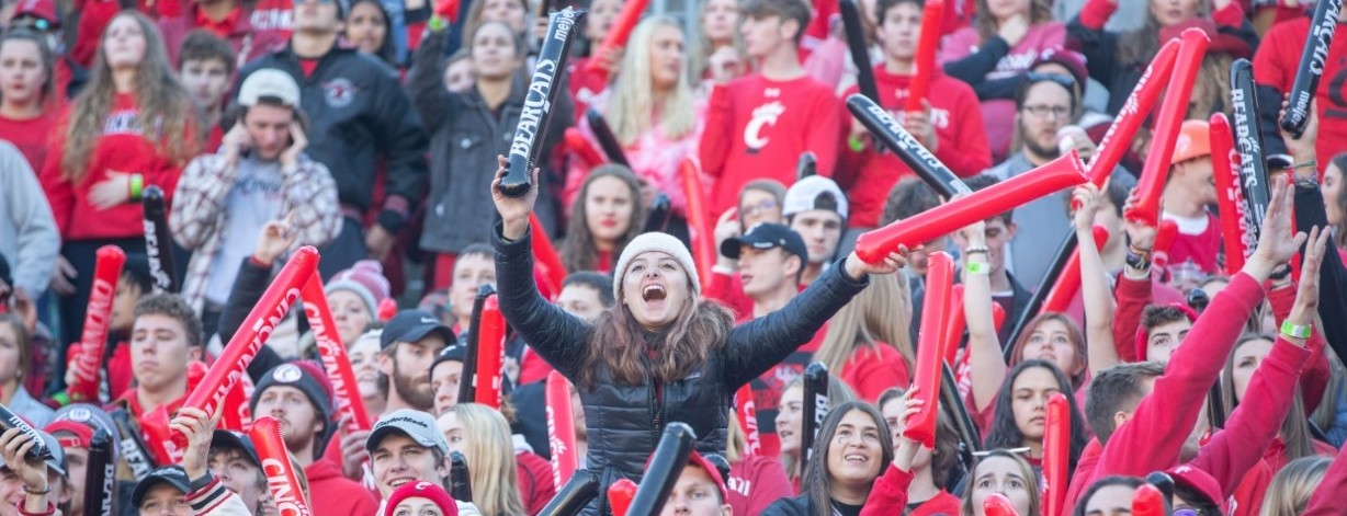 Fans cheer at a Bearcats football game.