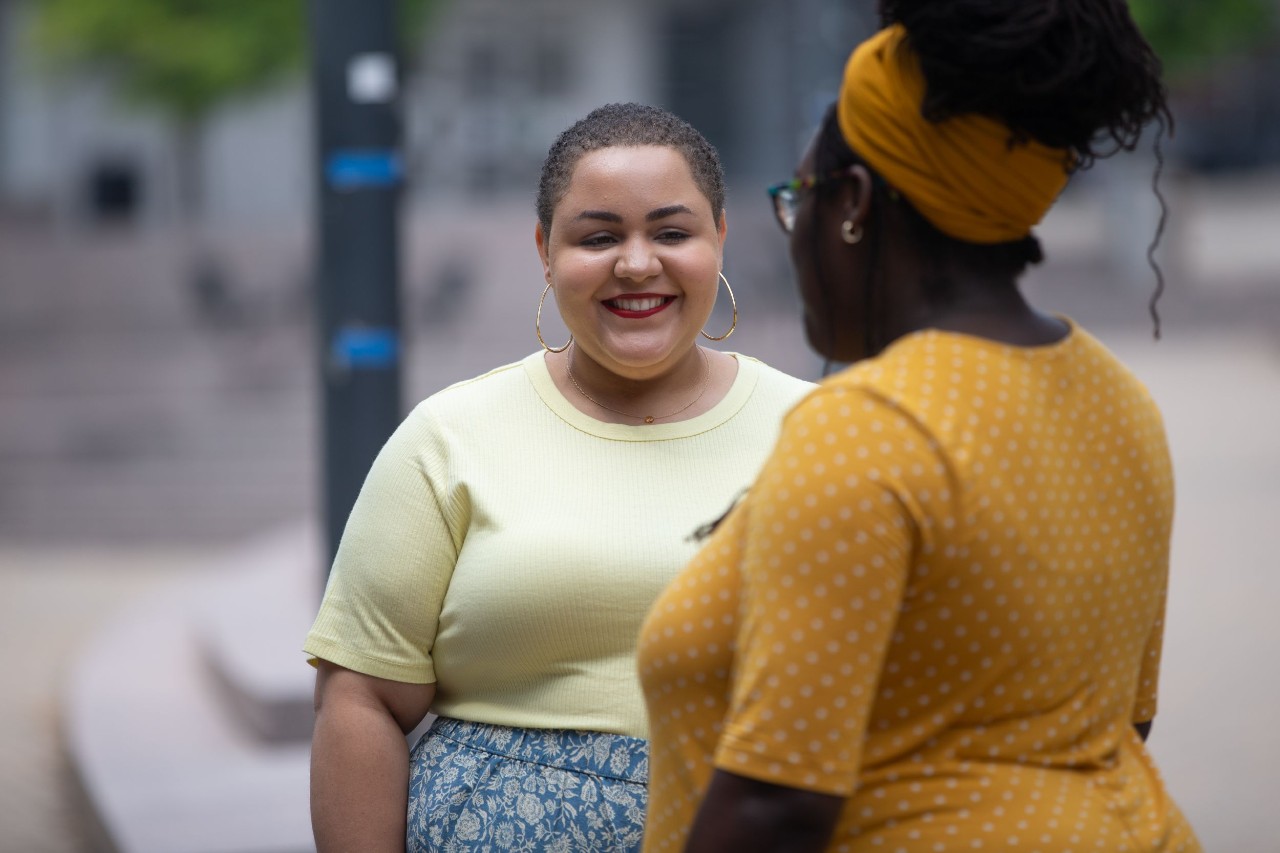 Camryn Morrow speaks to a friend whose back is to the camera