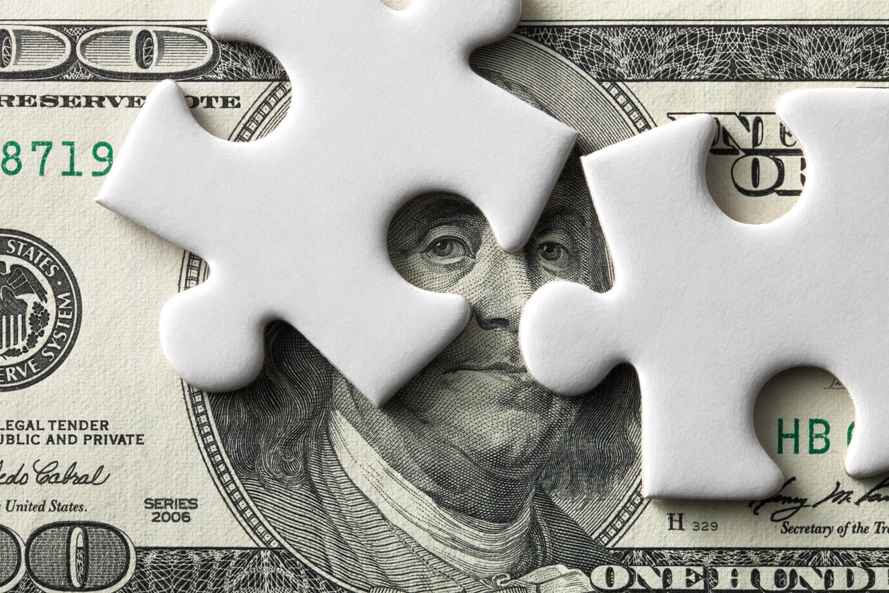 Money with puzzle piece