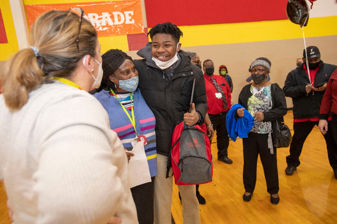 Jack Miner, Vice Provost for Enrollment Management surprised Jalen Tucker future UC Bearcats with Marian Spencer Scholarship awards at Shroder High School Tuesday February 1, 2022. Marian Spencer Scholarship a award students with full tuition, room and board and an all-expenses-paid study abroad experience from the University of Cincinnati. Photos by Joseph Fuqua II