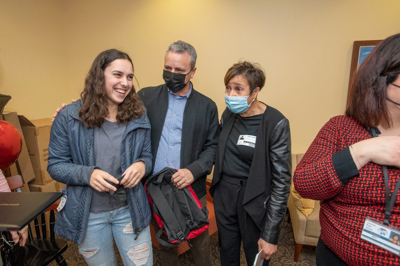 Jack Miner, Vice Provost for Enrollment Management surprised Julia Berman future UC Bearcats with Marian Spencer Scholarship award at Walnut Hills High School Tuesday February 1, 2022. Marian Spencer Scholarship a award students with full tuition, room and board and an all-expenses-paid study abroad experience from the University of Cincinnati. Photos by Joseph Fuqua II