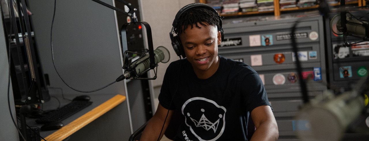 Miles Spearman in a studio in front of a microphone