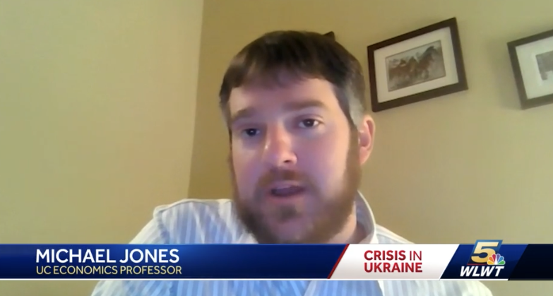 A man in a collared shirt speaks during an interview.
