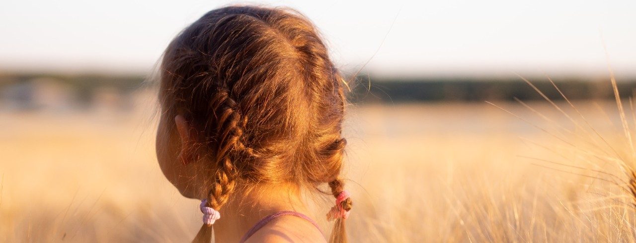 A girl stands in a field