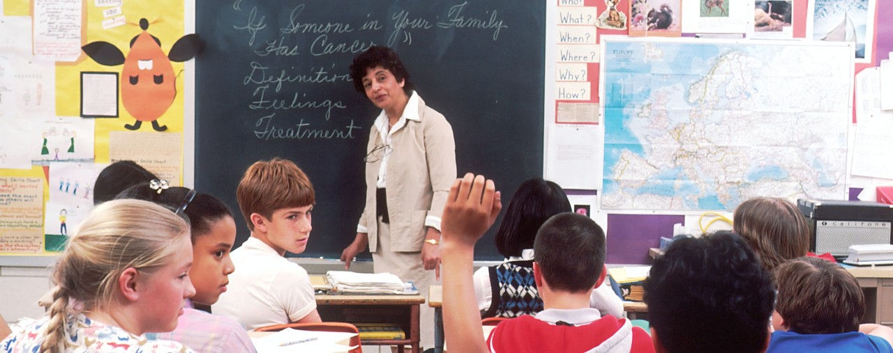 teacher at front of room with children