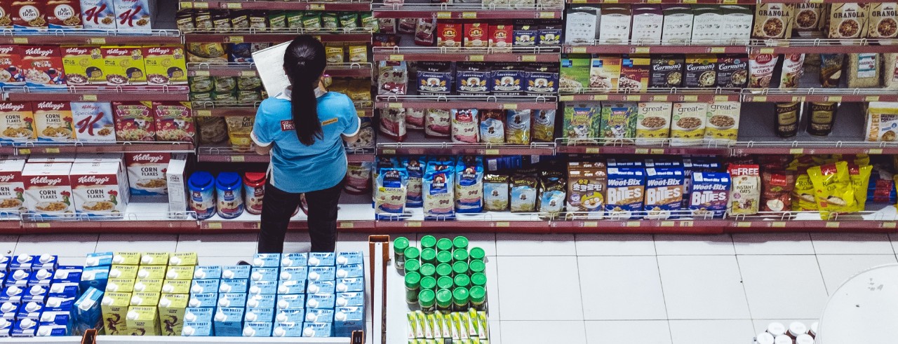 grocery store with employee checking shelves 