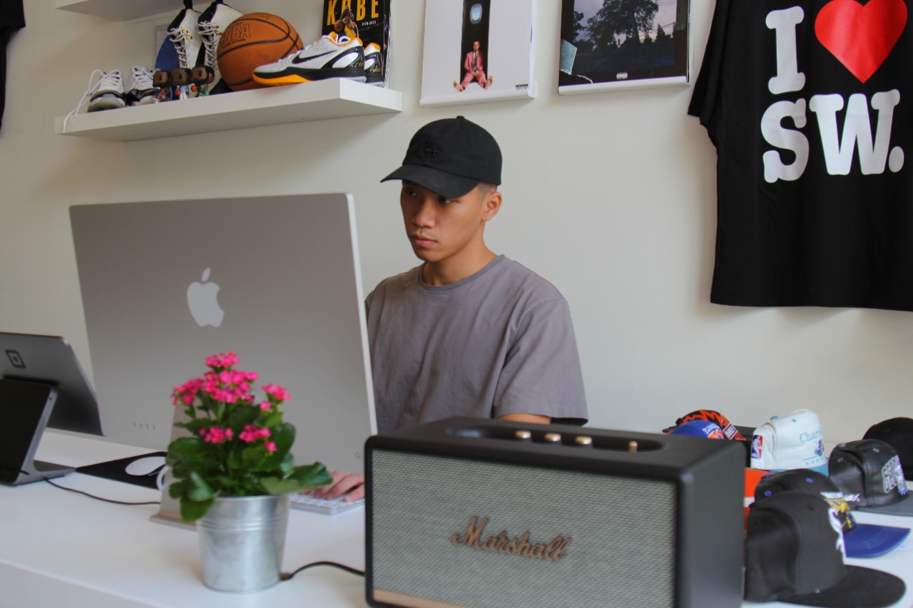 Nick Nguyen stands behind a computer at his store.