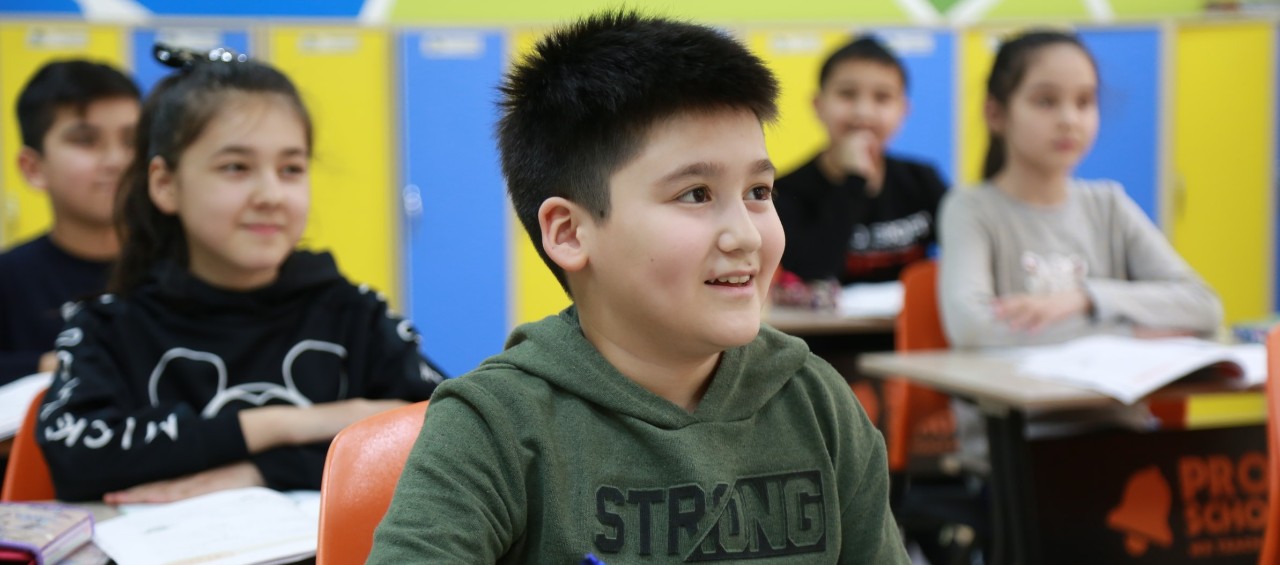 school children sitting at desks doing work