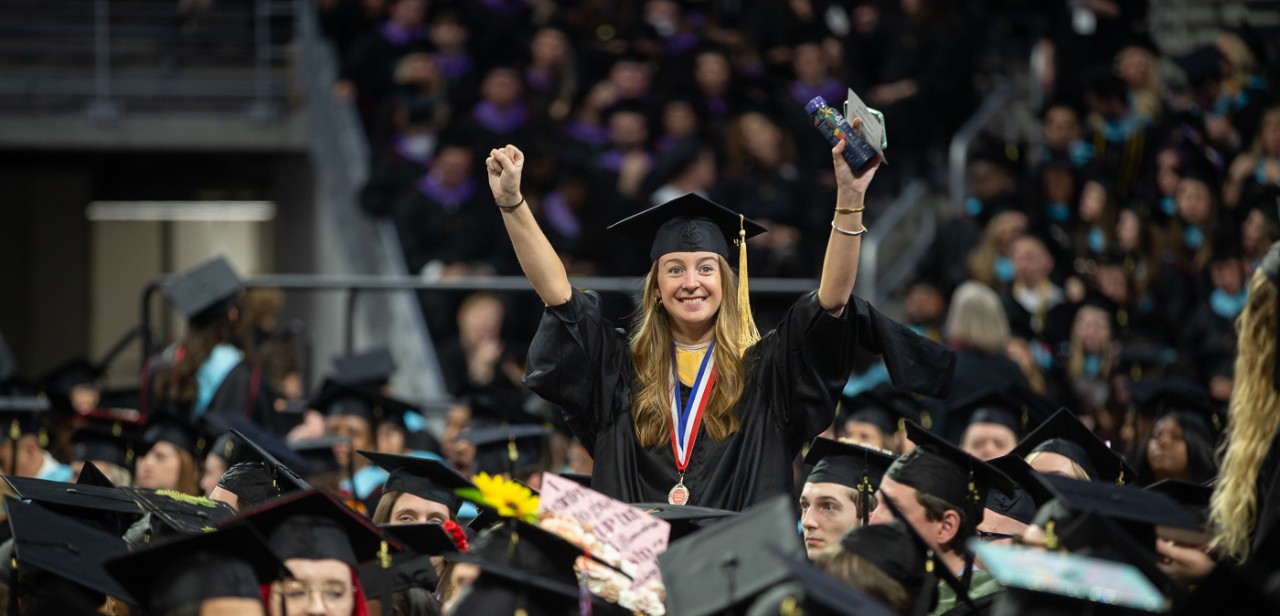 A grad celebrates at Fifth Third Arena.