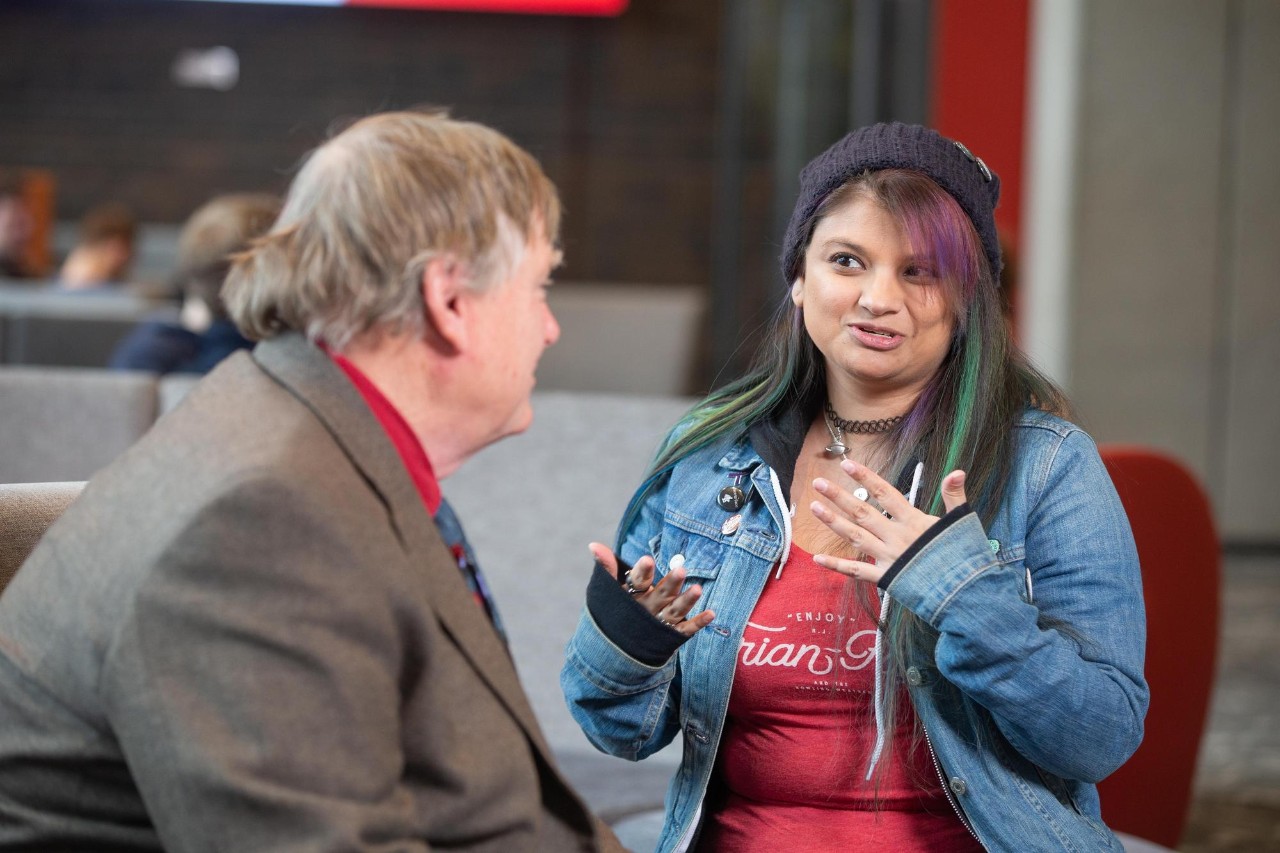 Matt Sauer, PhD, Assistant Director of Accessibility Resources at Clermont College, talks with a student.