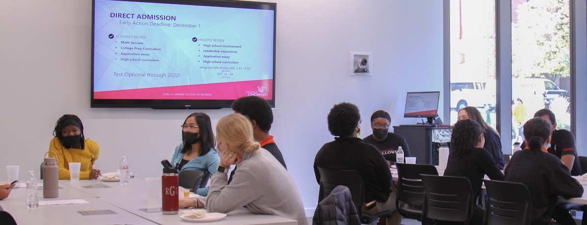Withrow students and current Lindner business students meet in a classroom to discuss admissions
