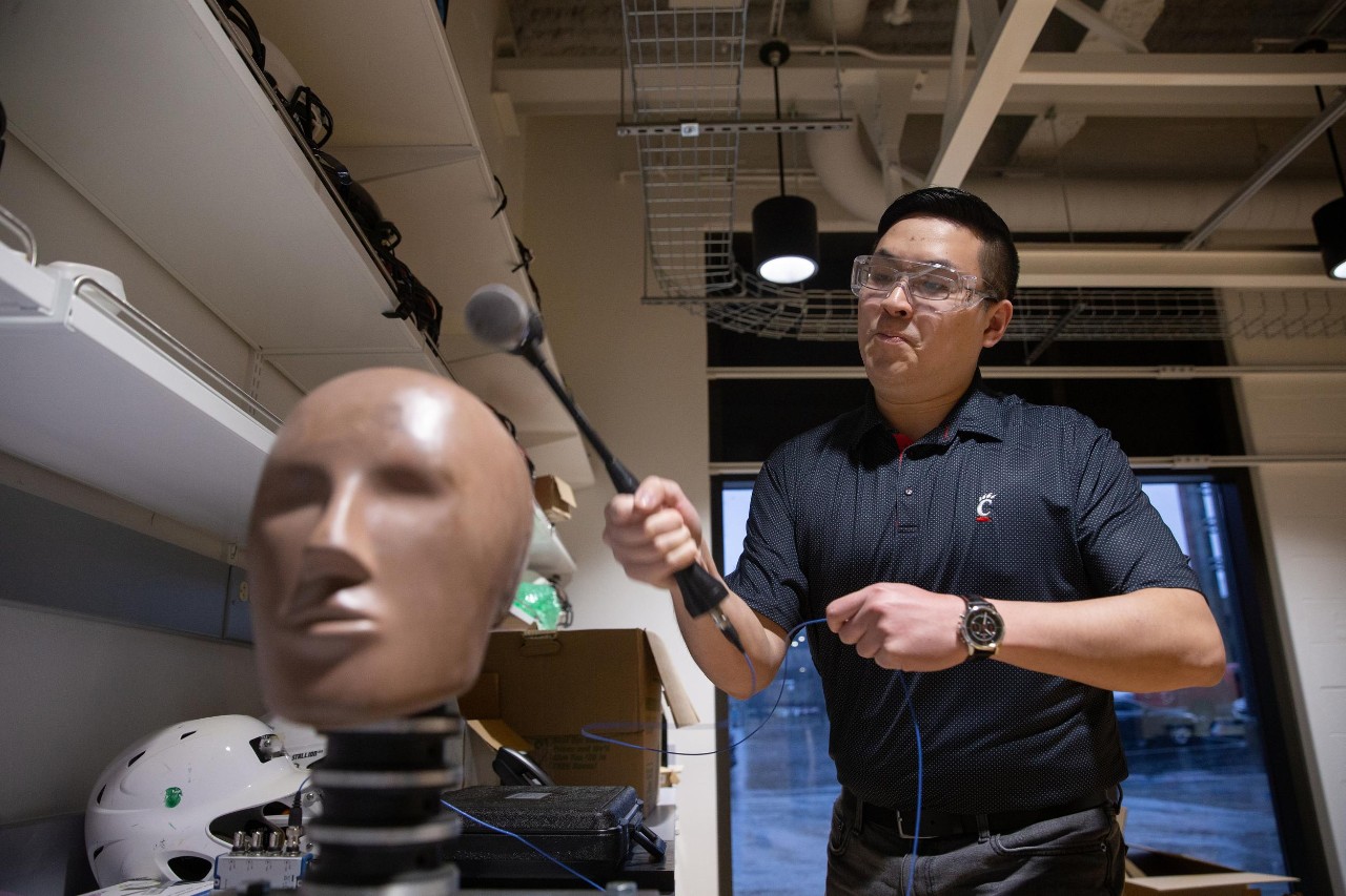 Led by Dr. Eric Nauman, a professor of biomedical engineering in UC’s College of Engineering and Applied Science, University of Cincinnati engineers put popular football helmets made by leading brands through impact testing and found that no single design demonstrated superior reduction of potential concussion incidence or consistent energy absorption at every part of the helmet. Research assistants: Sean Bucherl (ball cap), Christopher Boles (UC sweatshirt), and Shengming Hu (UC polo).