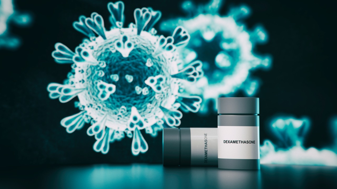 Illustration of a COVID-19 molecule next to bottles of dexamethasone